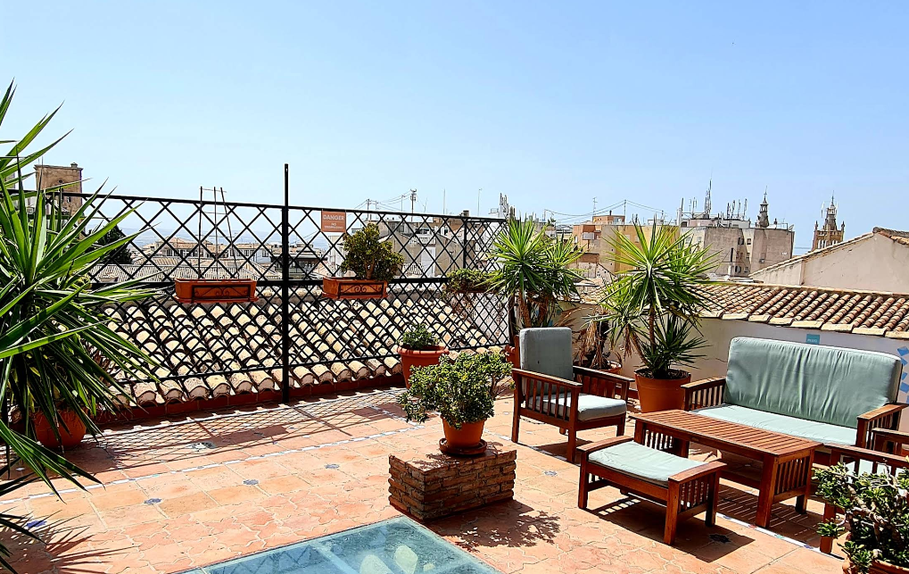 Oasis Backpackers hostel rooftop terrace with views towards the Alhambra in Granada