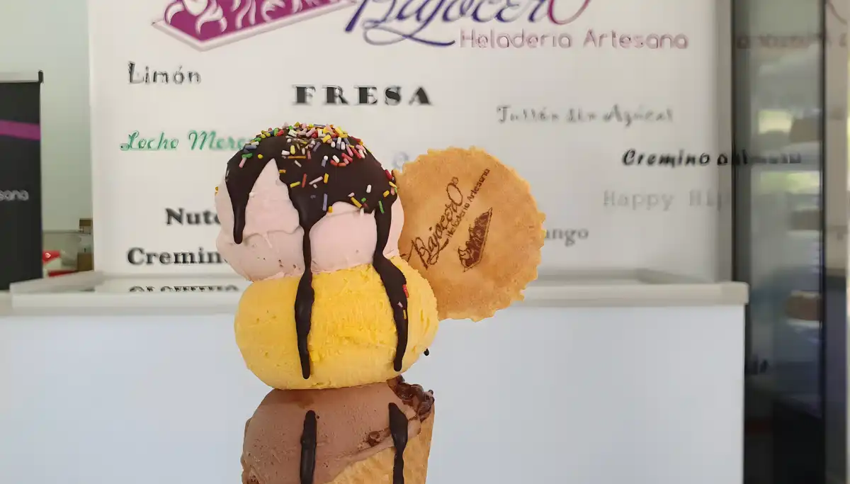 Triple scoop ice cream cone with chocolate drizzle from Bajocero in Malaga