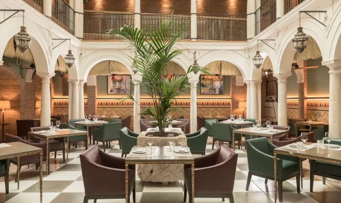 Palacio Solecio hotel courtyard with original tilework and columns in Malaga's Old Town
