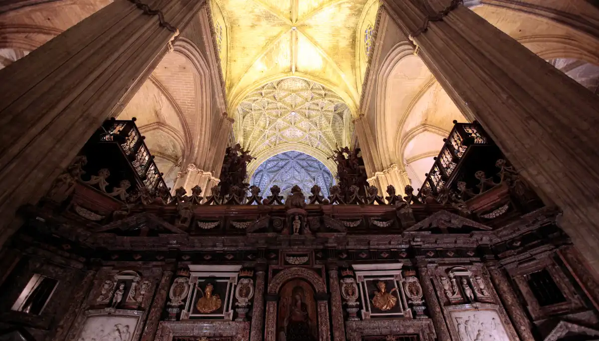 Ornate vaulted ceiling and altarpiece inside Seville Cathedral
