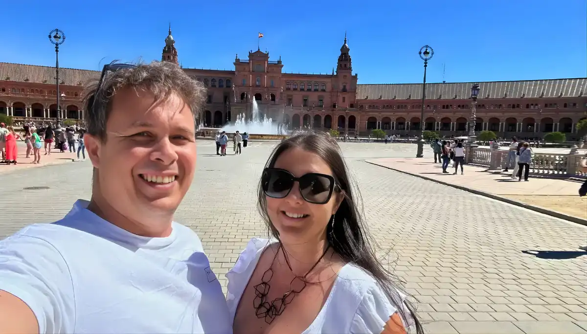 Couple at Plaza de Espana in Seville with the fountain and main building behind