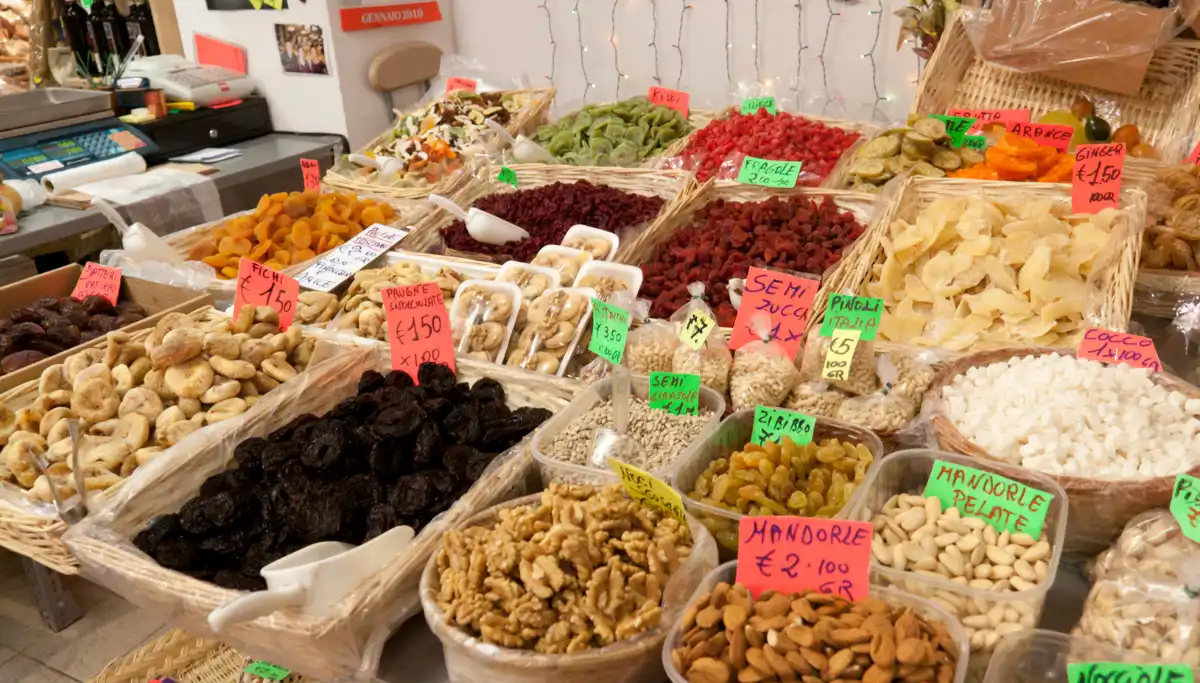 Dried fruits, nuts, and spices at a market stall in the Triana Market