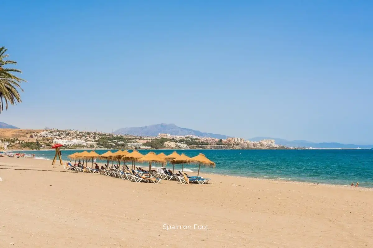 cabanas on golden sand with a turquoise ocean on playa Arroyo Vaquero.
