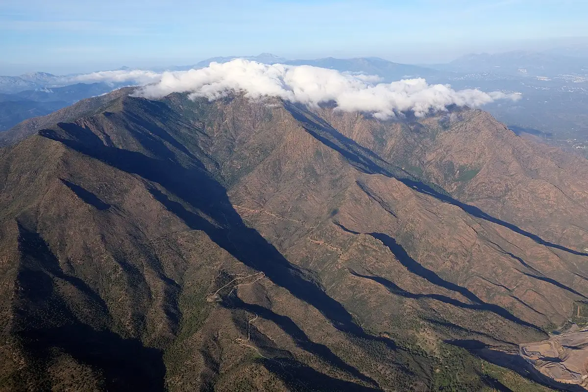 a high-level view of the Sierra Bermeja mountains in Estepona with light clouds over them.