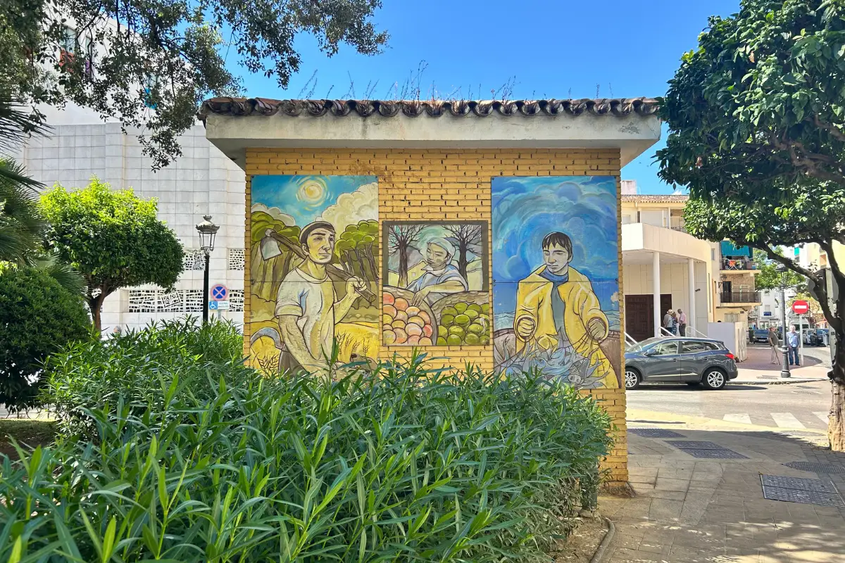 Street mural of farmers painted on a building wall in Estepona old town