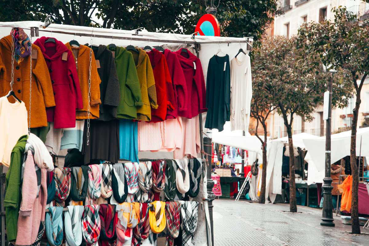 Colourful clothing and textile stalls at the weekly outdoor market in Estepona