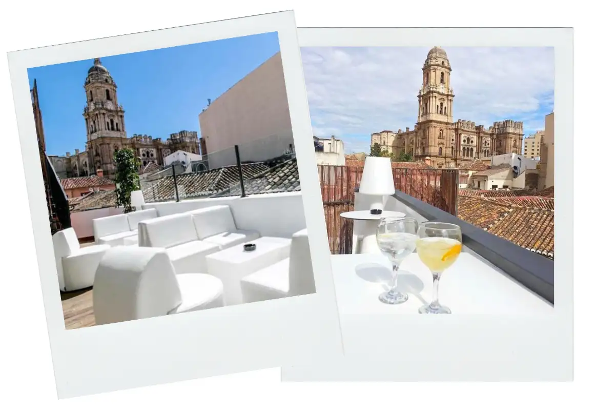 couches on the terrace of Chinitas Urban hostel with the Malaga cathedral spire and blue skies i the background.