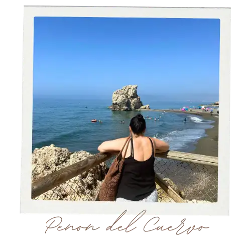 A woman peering over a lookout on the beach at Crows rock at Playa del Penon del Cuervo.