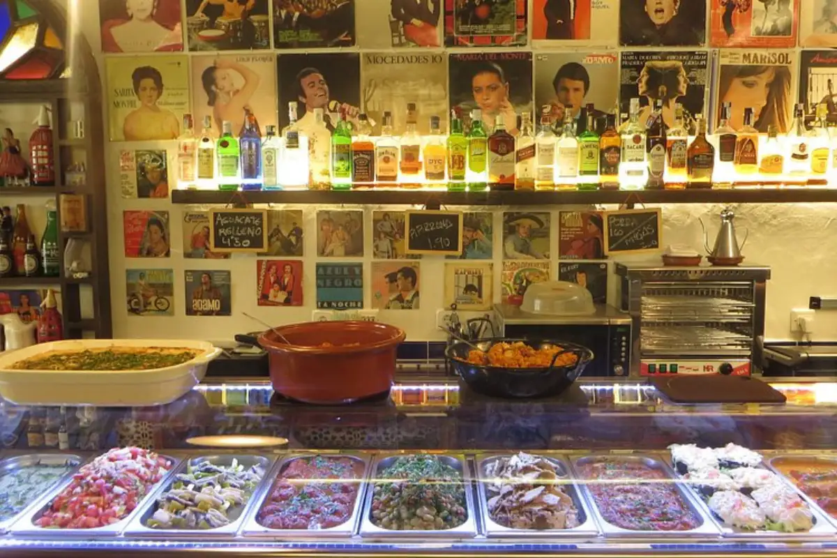 A variety of food on top and behind a counter at La Tranca bar in Malaga.