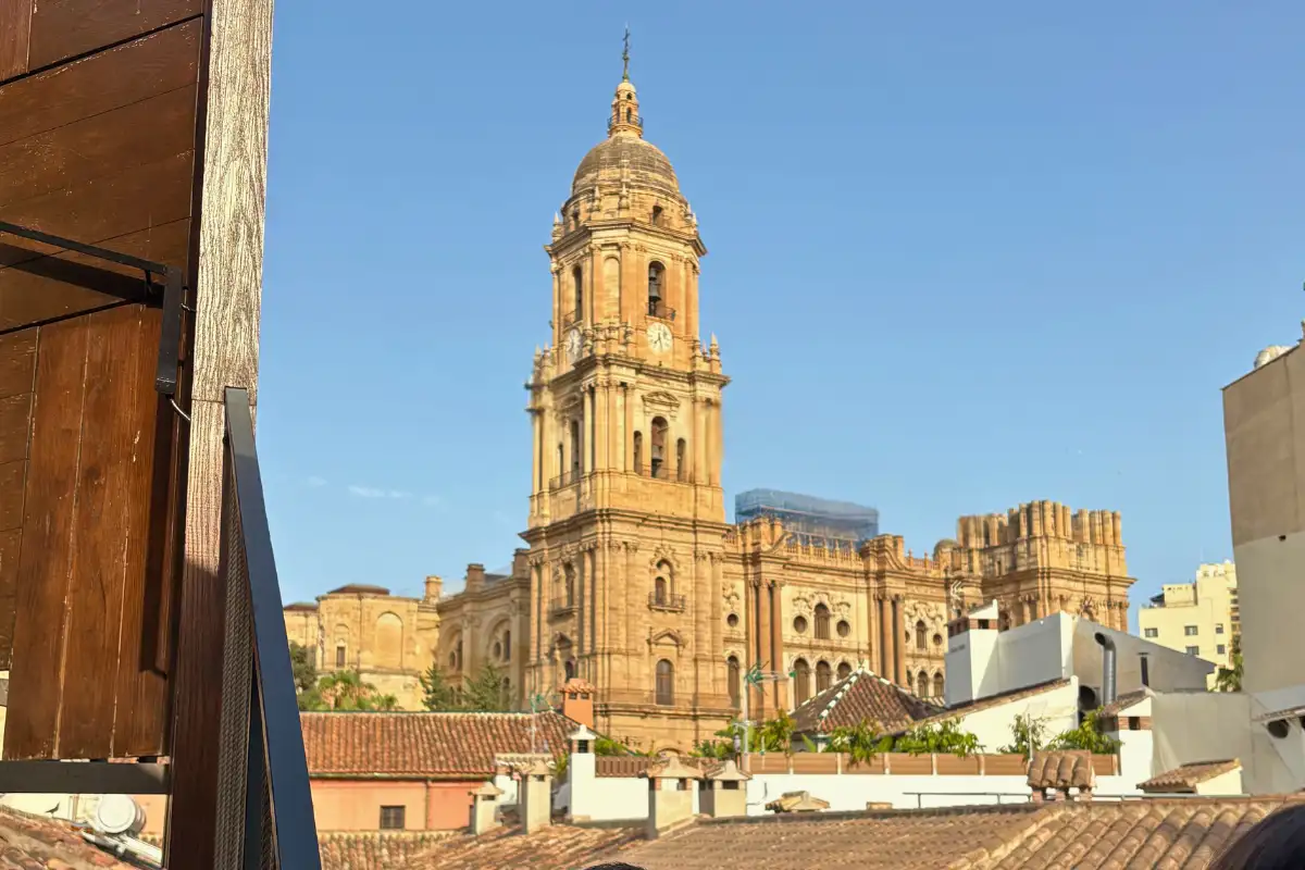 View of Málaga Cathedral tower from a rooftop bar terrace in the old town