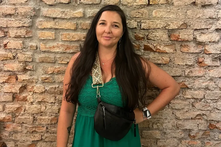 Woman with a crossbody bag wearing a money belt to stay safe from tourist scams in Spain