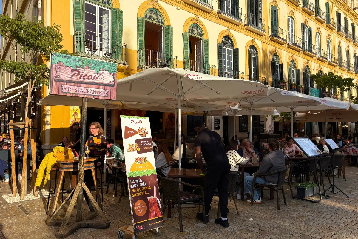 Outdoor tables with umbrella covers at Picasso Bar on Plaza de la Merced, Málaga