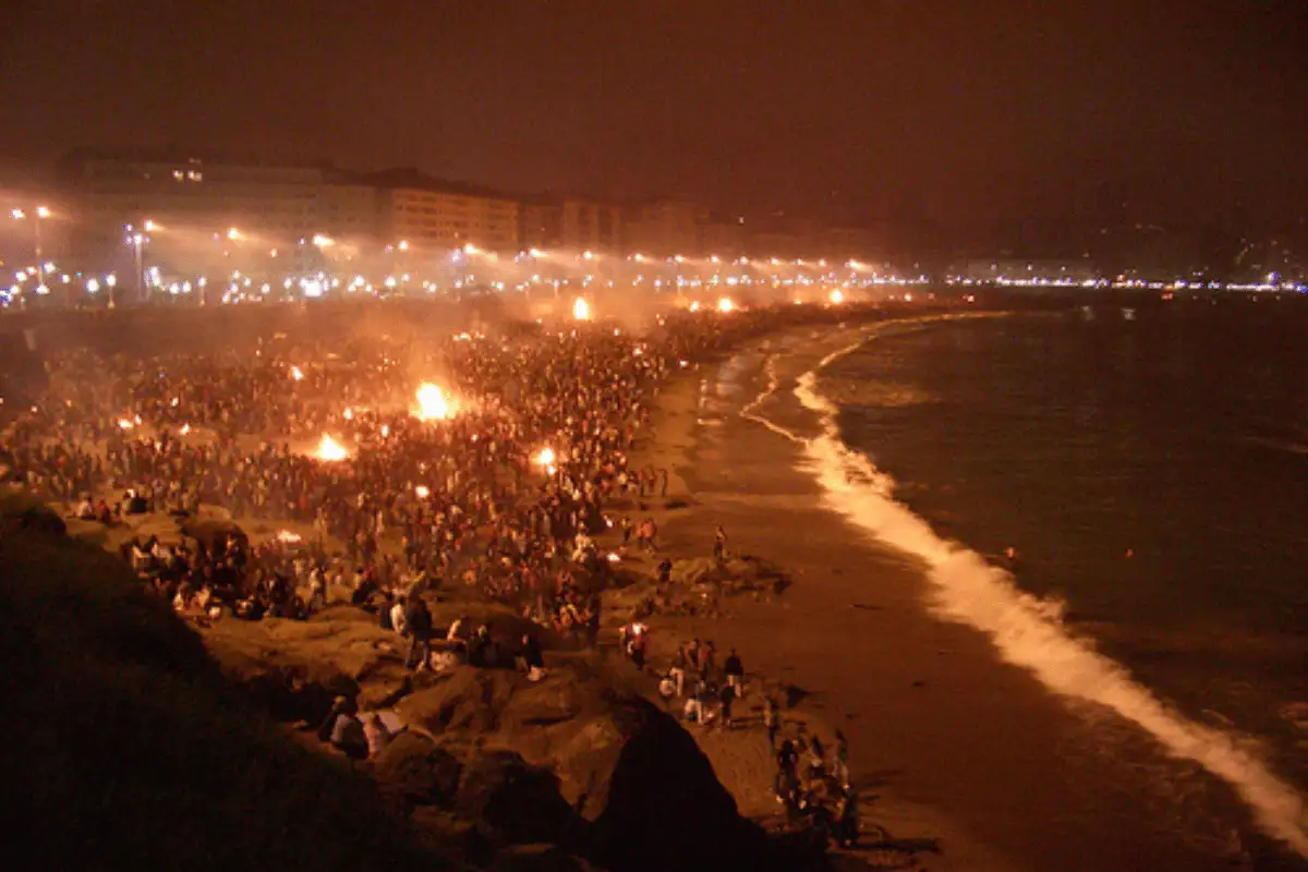 Bonfires burning on a Malaga beach at night during Noche de San Juan