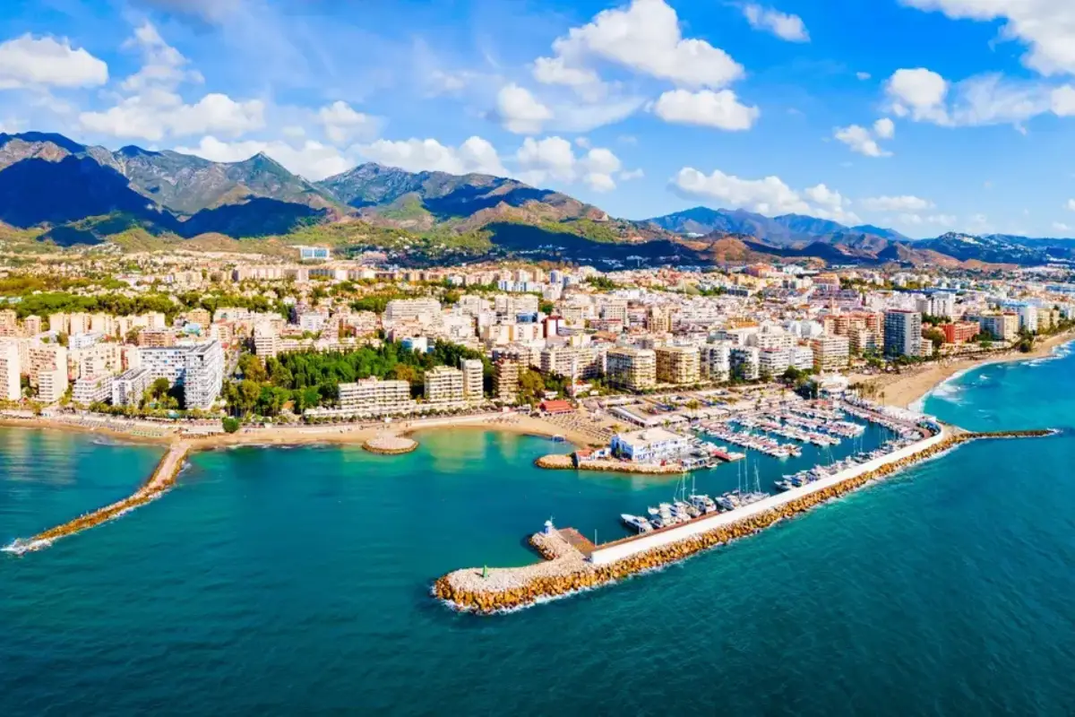 A top down view of the port in Marbella with the mountains in the background.