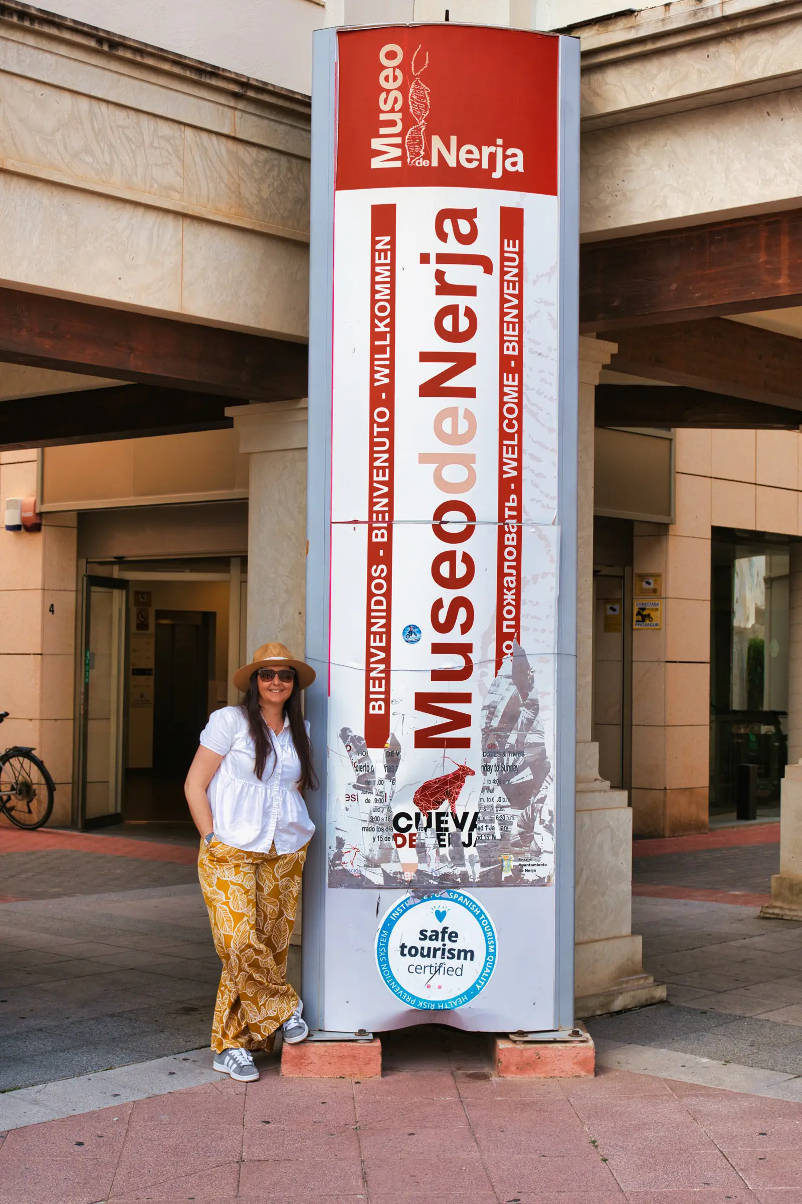 heidi standing next to the museum sign in nerja