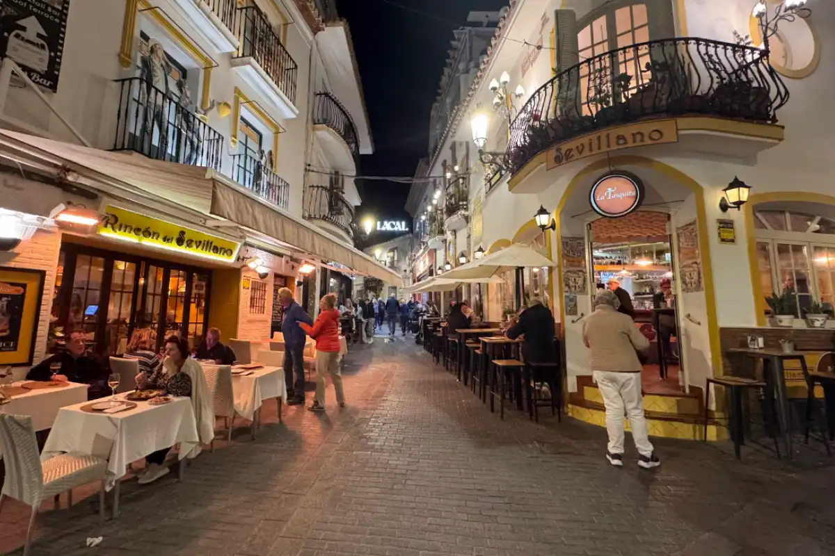 Nerja old town at night with all the lights and restaurants lit up.