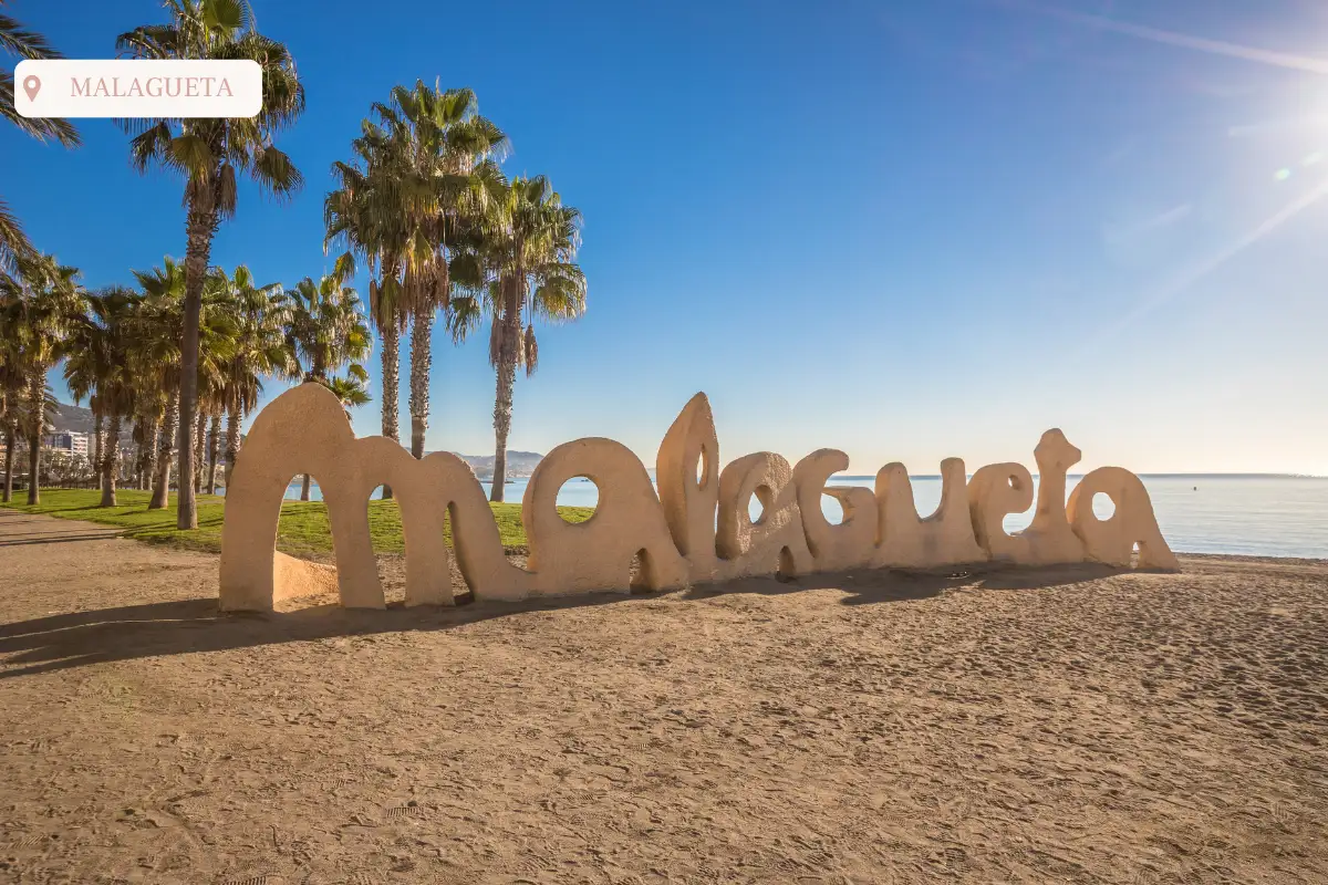 The malagueta sign with blue sky and palm trees at playa Malagueta.