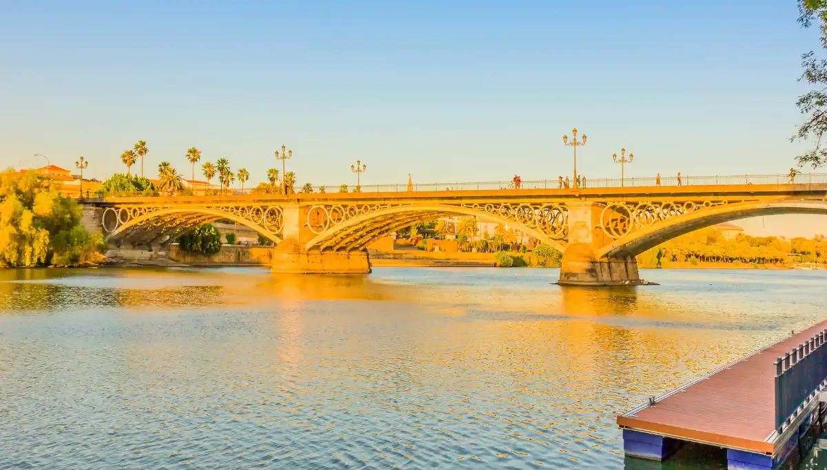 The Triana bridge crossing the Guadalquivir at sunset, near the Los Remedios neighbourhood