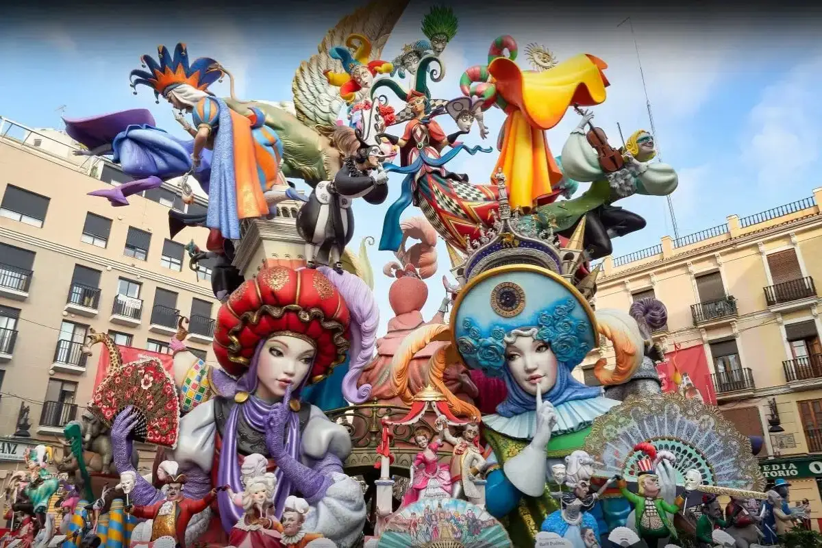 Giant decorative Fallas figures towering over a square during the Las Fallas festival in Spain
