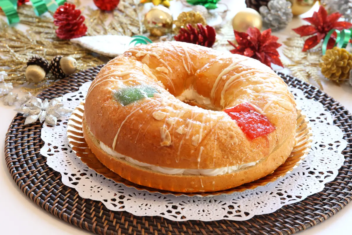 Roscon de Reyes ring cake on a plate decorated with dried fruit for Three Kings Day