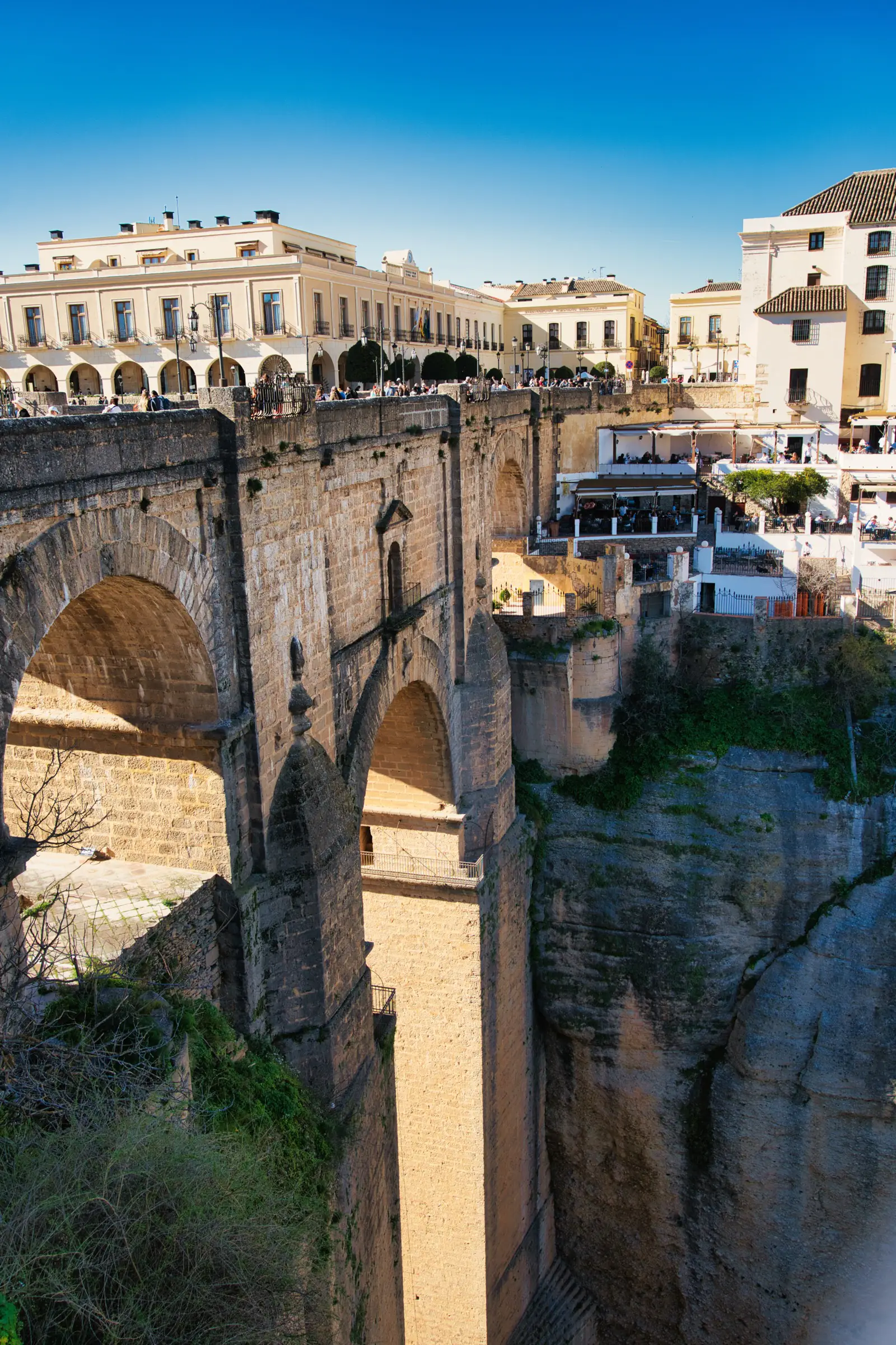 Puente Nuevo bridge in Ronda with restaurants on the cliff edge.
