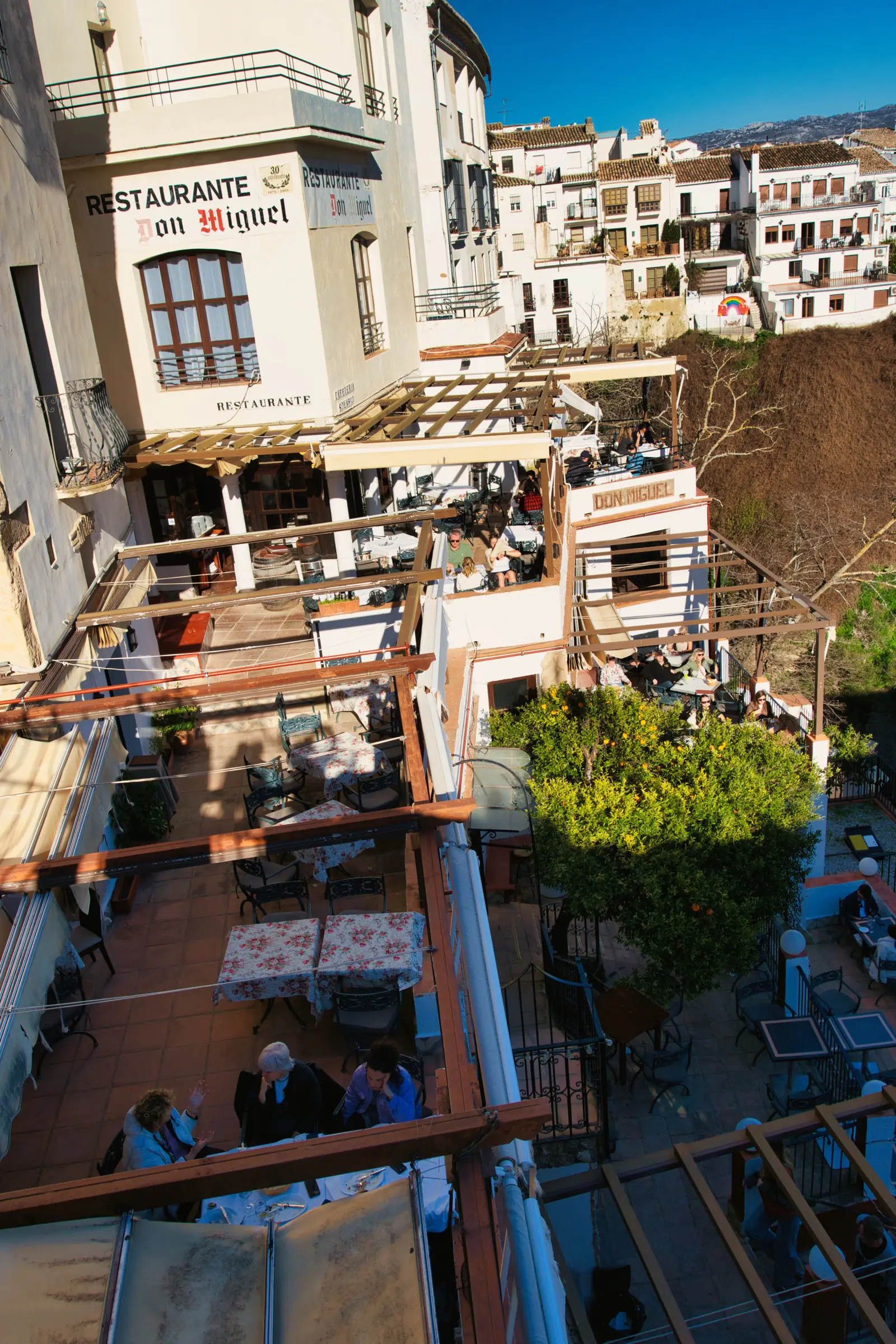 Restaurants perched below Puente Nuevo.
