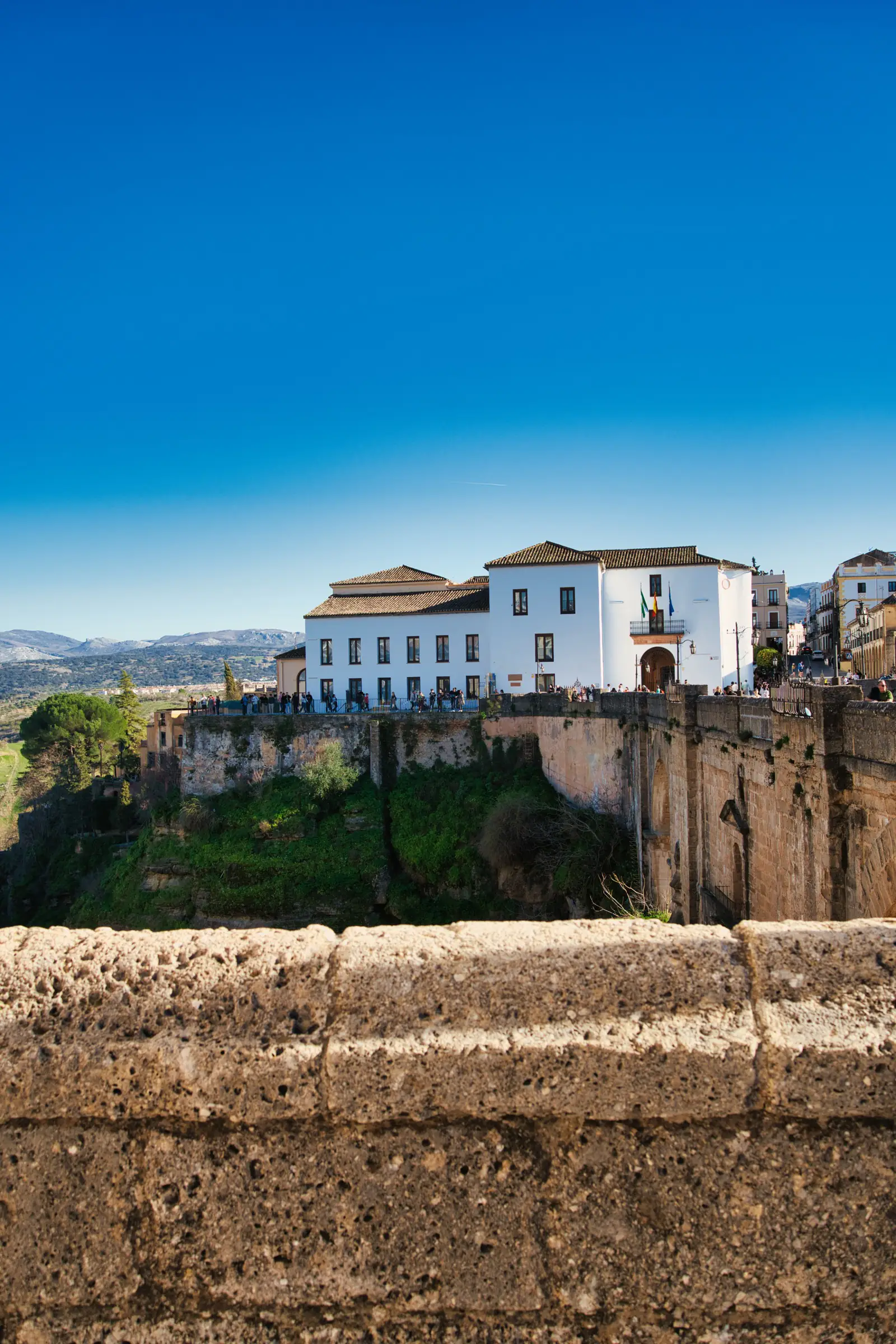 Side view of Ronda's gorge and historic bridges.