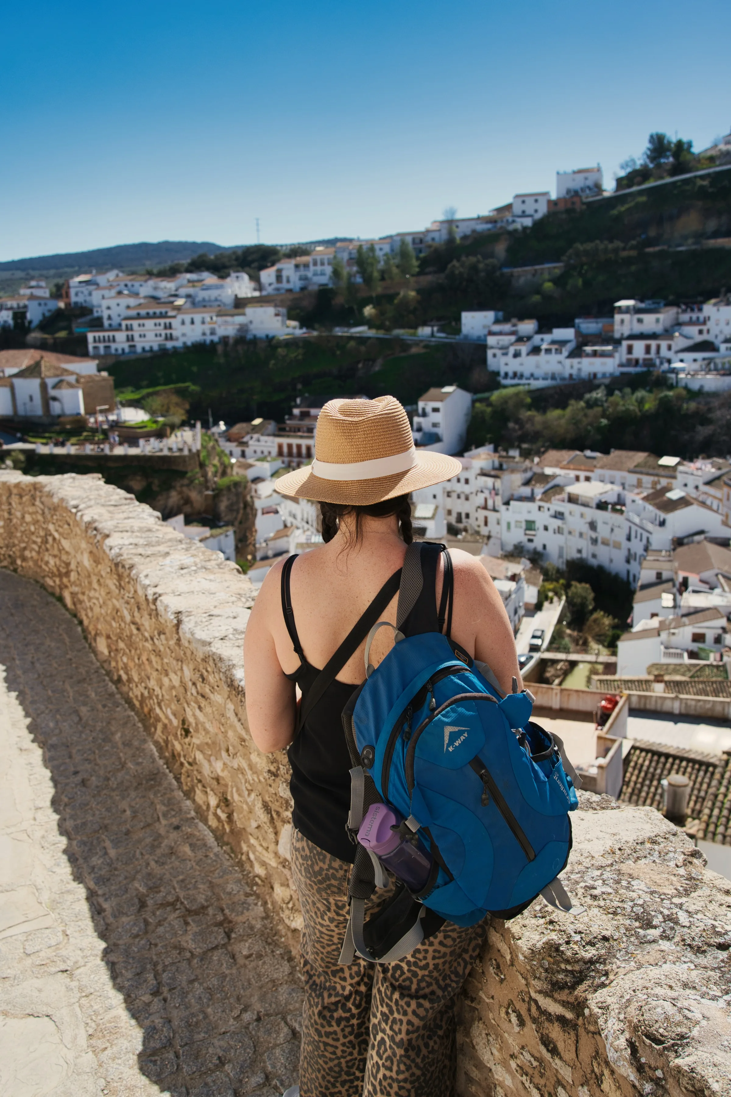 Woman looking down at houses built into a hill.