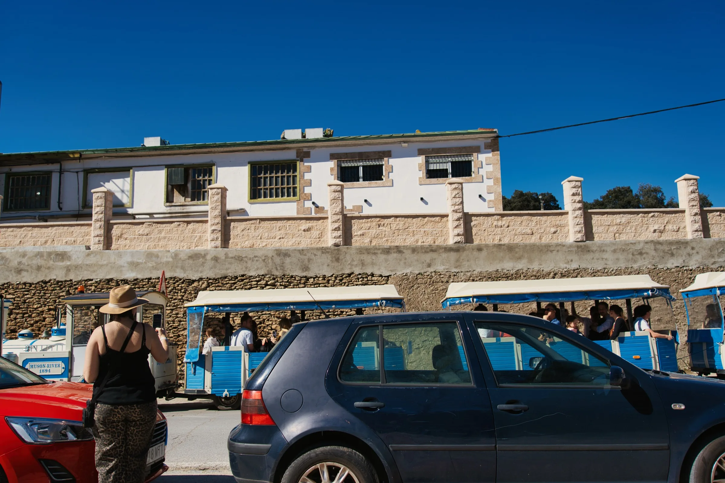 A blue train carrying people from the parking lot to the caves.